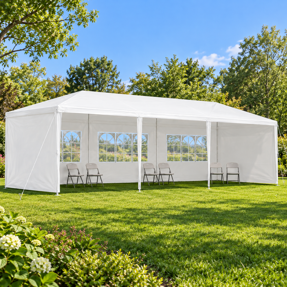 10 × 30-ft. Party Canopy with 5 Sidewalls, White, on a garden lawn with chairs inside