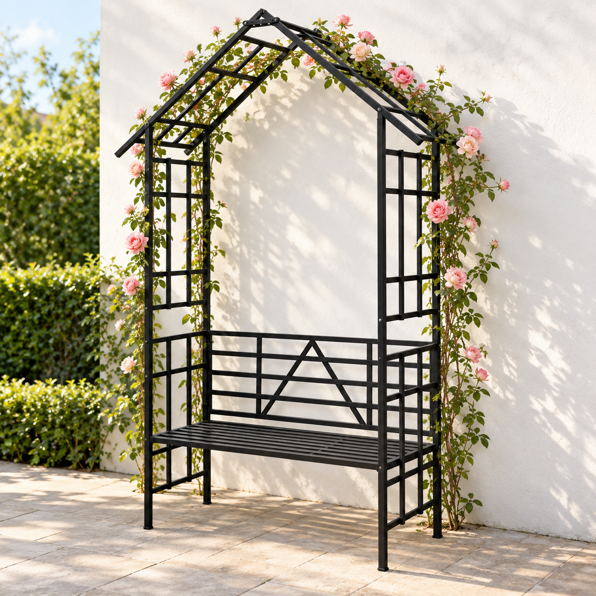 97-in. Gabled Iron Garden Arbor with Bench, Black, on a garden patio with climbing roses