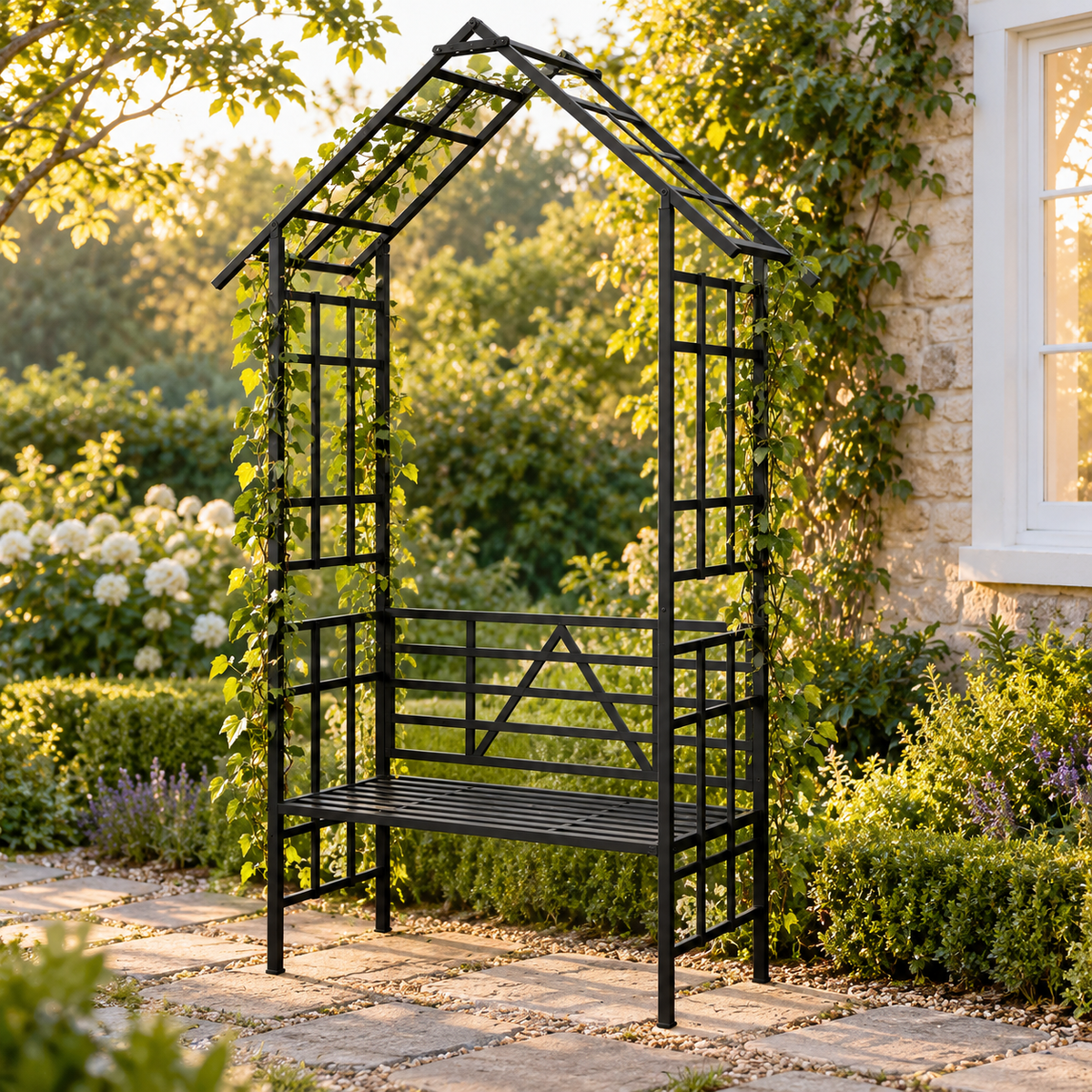 97-in. Gabled Iron Garden Arbor with Bench, Black, beside a cottage garden path