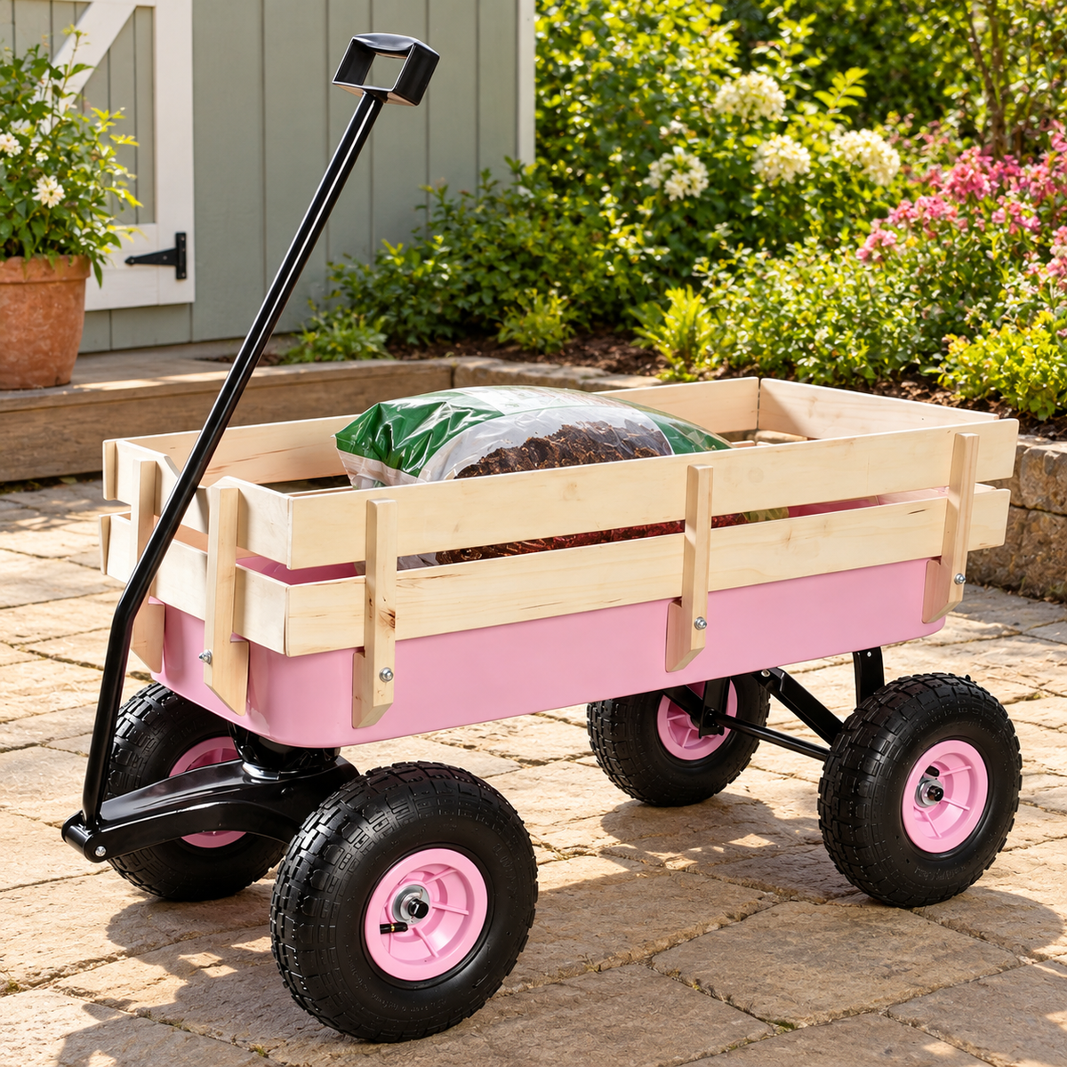 Garden Wagon with Wood Rails and Air Tires, Pink, on a patio beside a garden shed